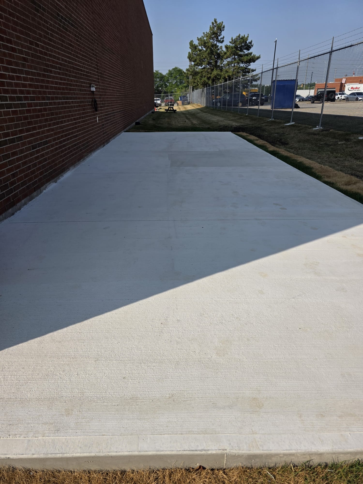 Finished Concrete Pad — Commercial Brick Building, Completed Work