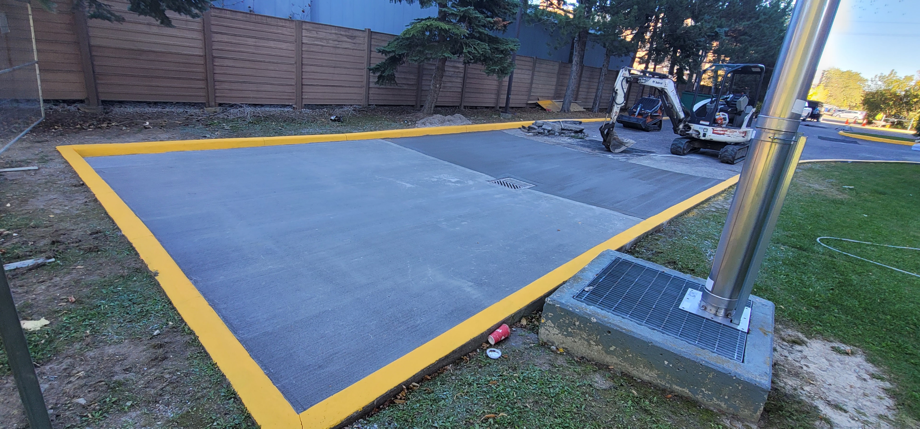 Concrete Pad with Yellow Safety Border & Drain Integration, Commercial Property