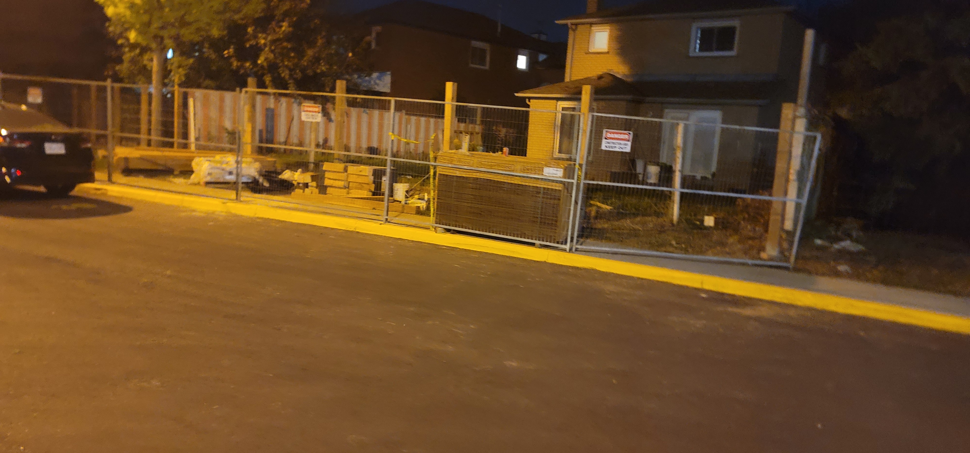 Construction Site — Safety Fencing & Danger Signage, Night View