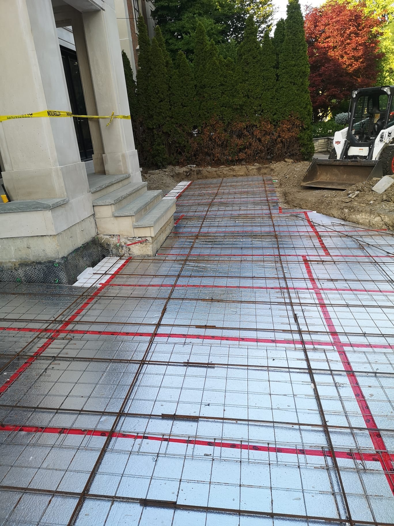 Heated Driveway Prep — Rebar Grid & Red Insulation Board, Stone Entrance