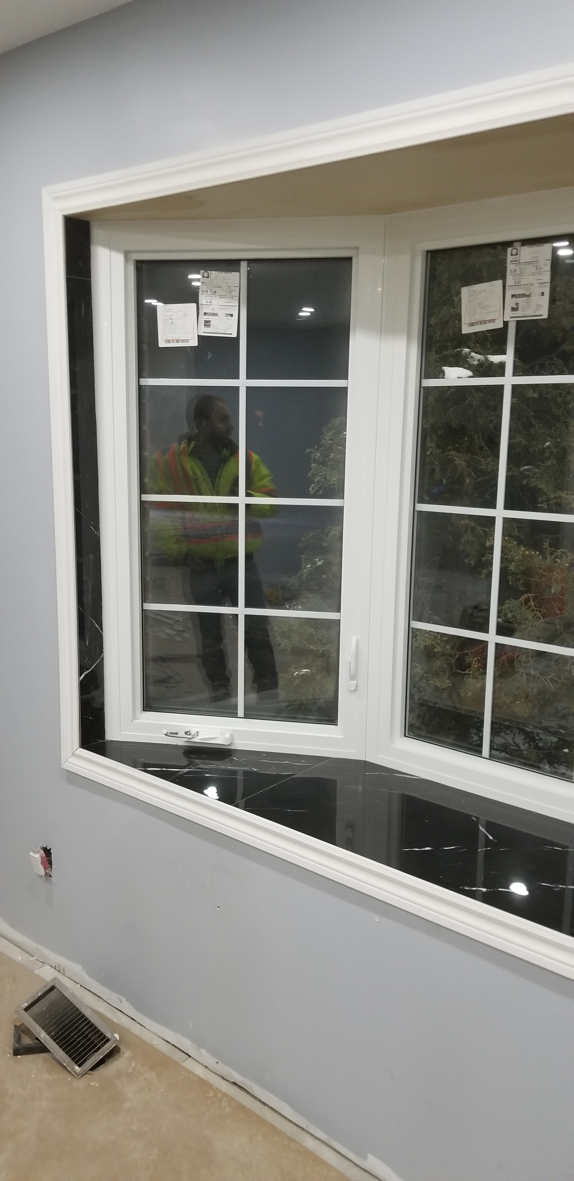 New Window Installation — Worker in High-Vis Vest, Commercial Unit