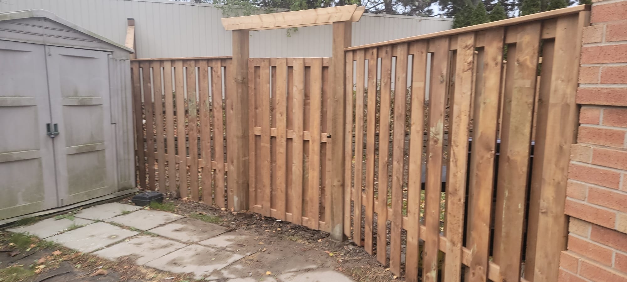 Wood Fence with Pergola Gate — Backyard View with Shed, Commercial Housing
