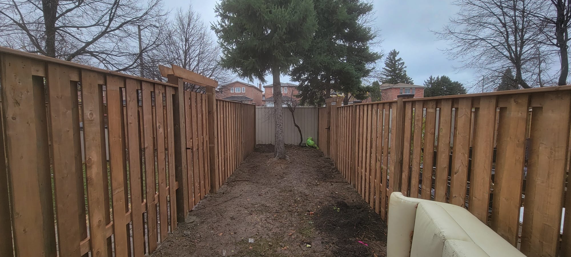 Full Perimeter Wood Fence — Wide Backyard View, Commercial Housing Unit